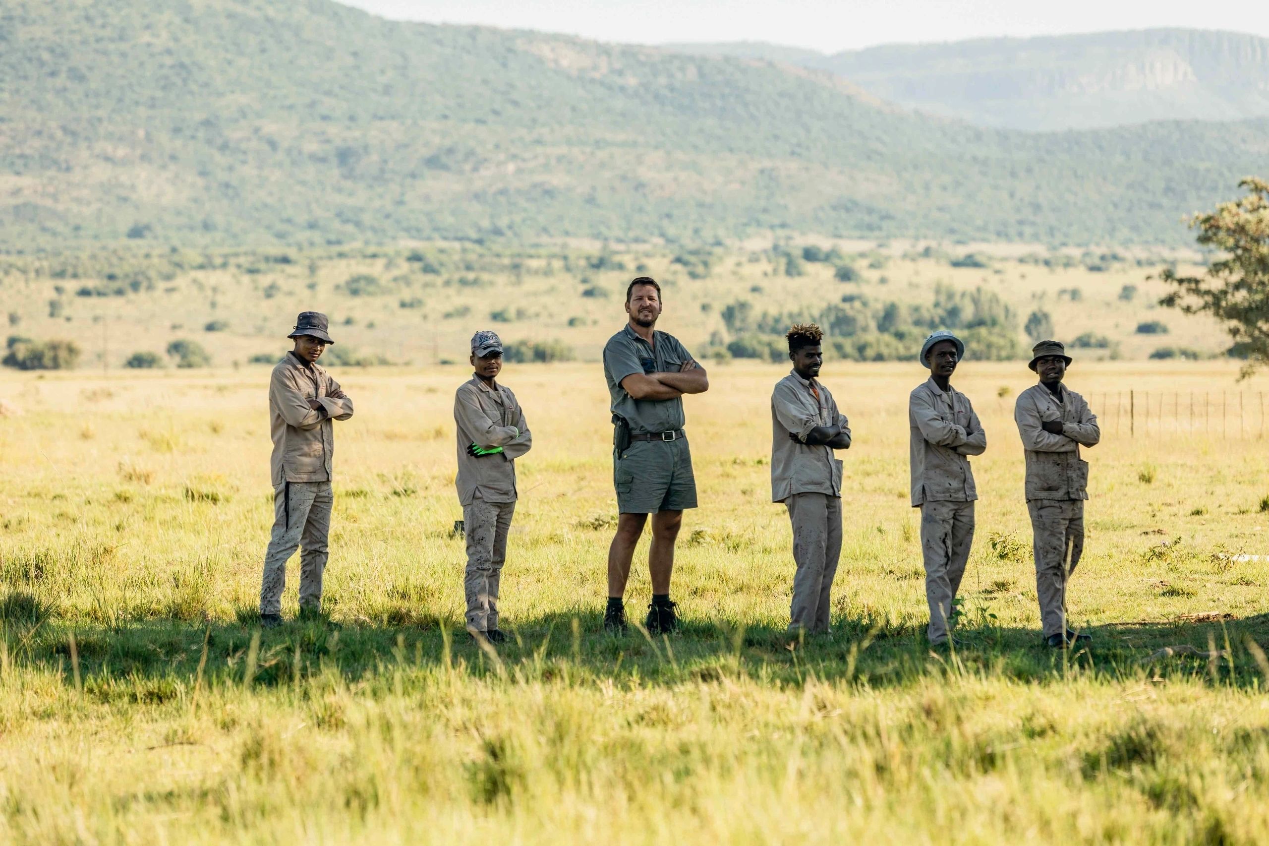 Park rangers team in grassland valley